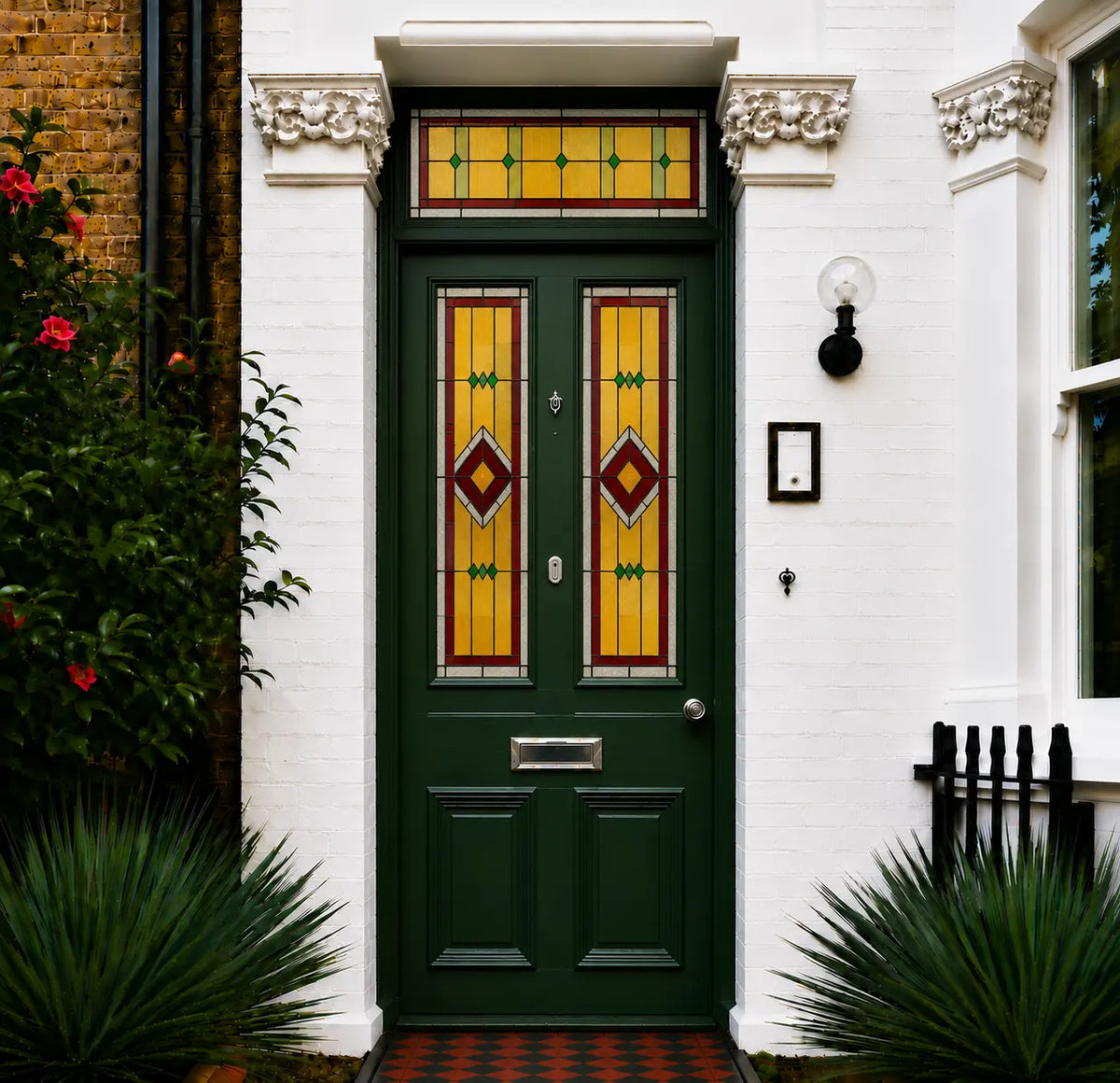 Art Deco stained glass window film for front doors with amber, red and green geometric panels and matching transom.