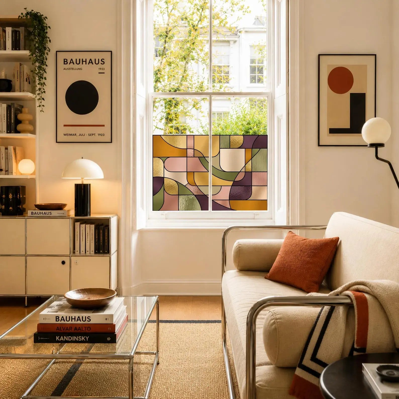 Self-adhesive stained glass privacy window film transforming a living room window with contemporary geometric artwork.